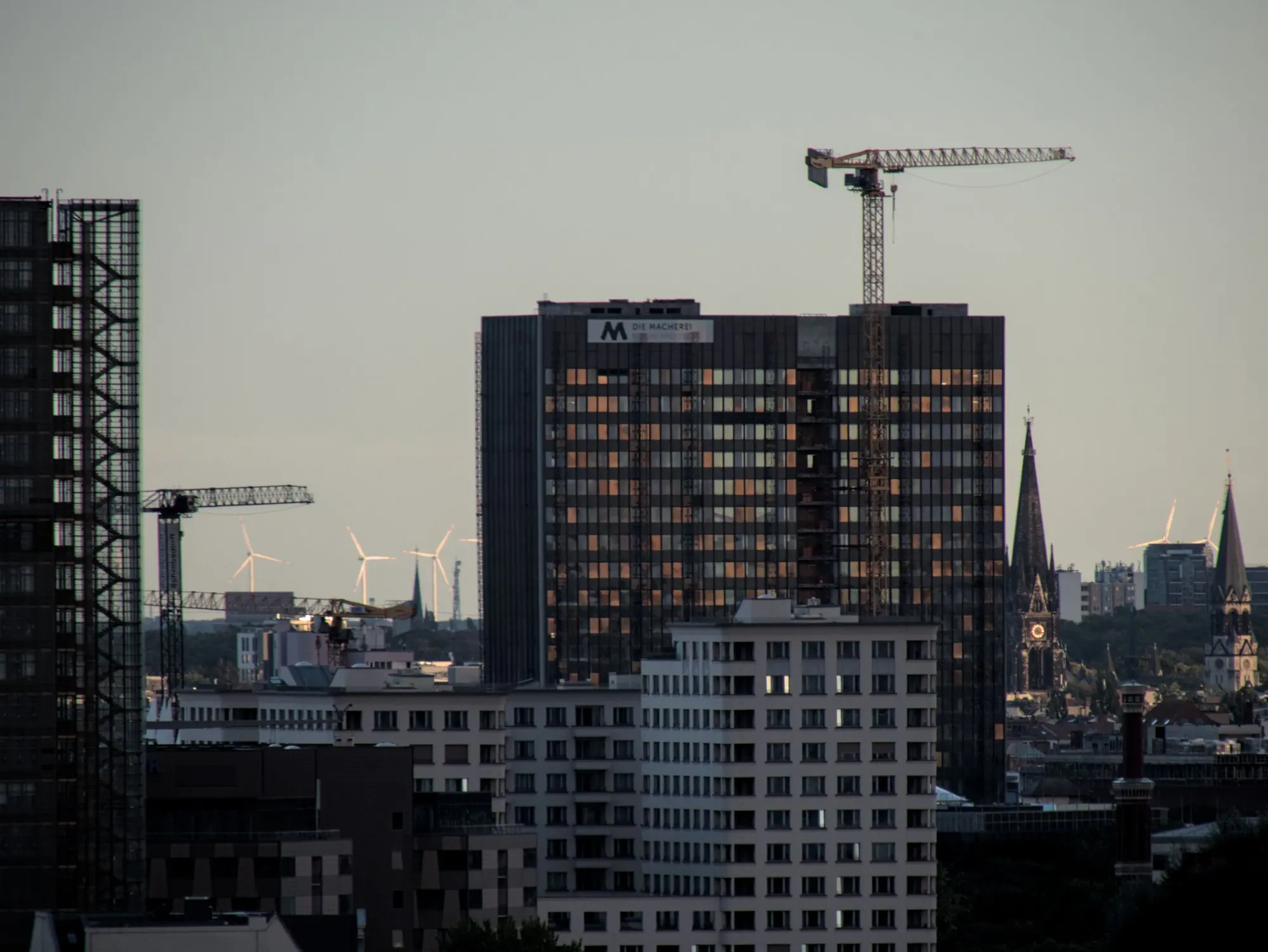 Tower cranes over a city skyline