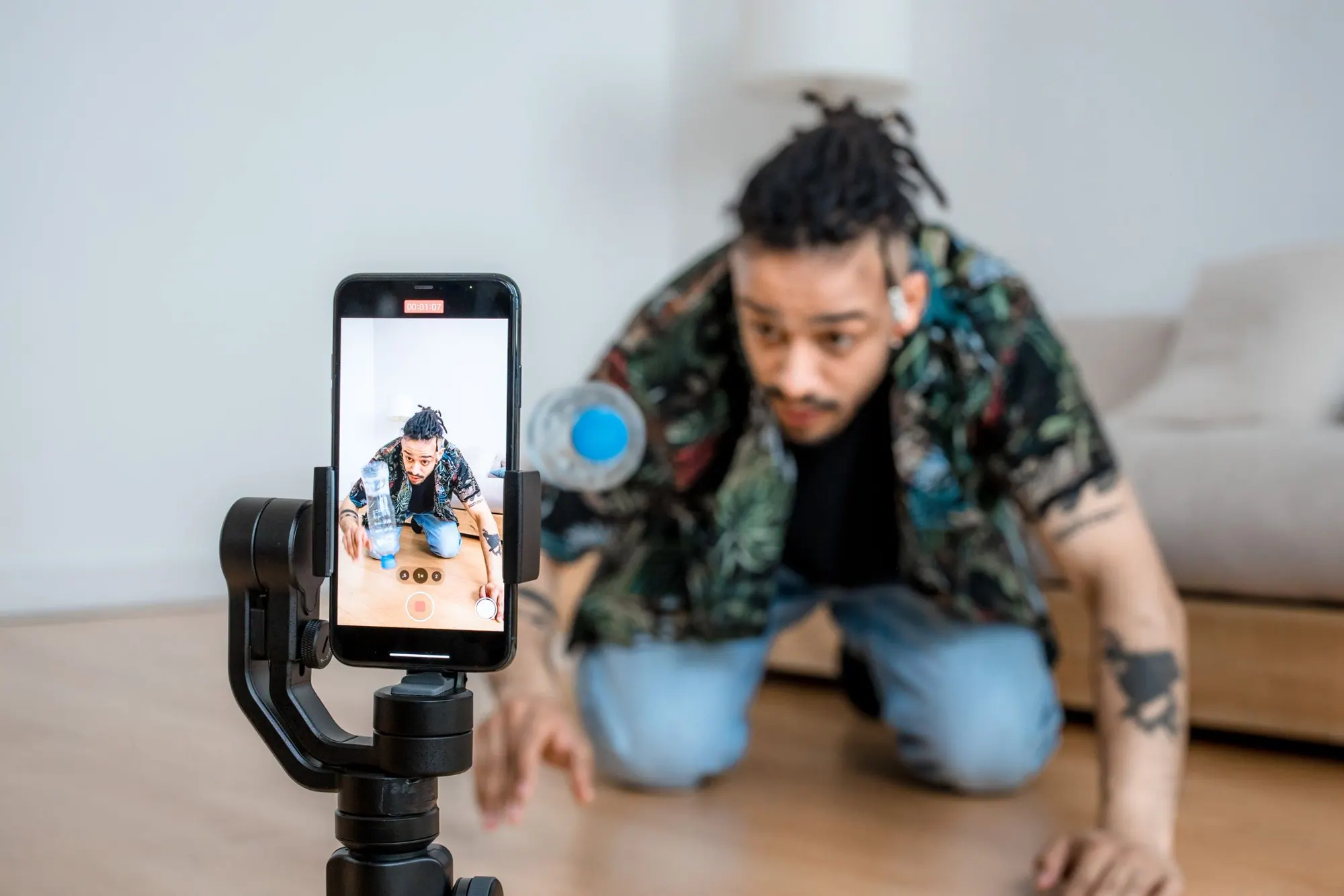 Creator filming with a phone and ring light