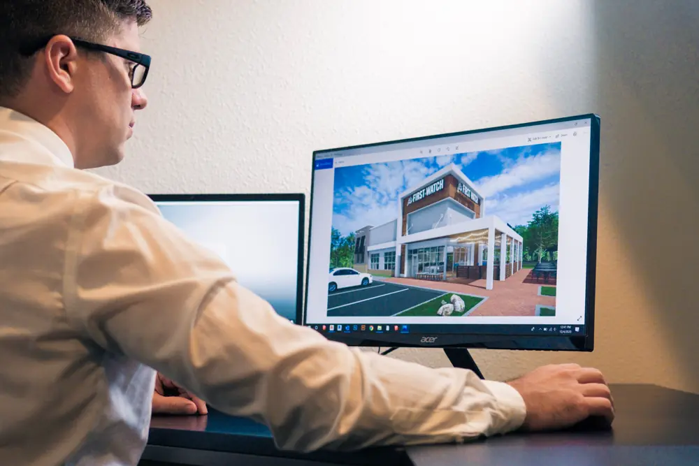 Architect reviewing a building model on a monitor