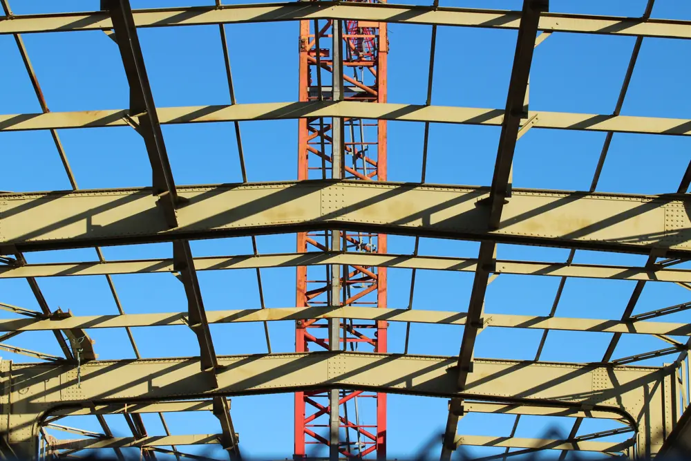 Steel roof trusses with a tower crane beyond